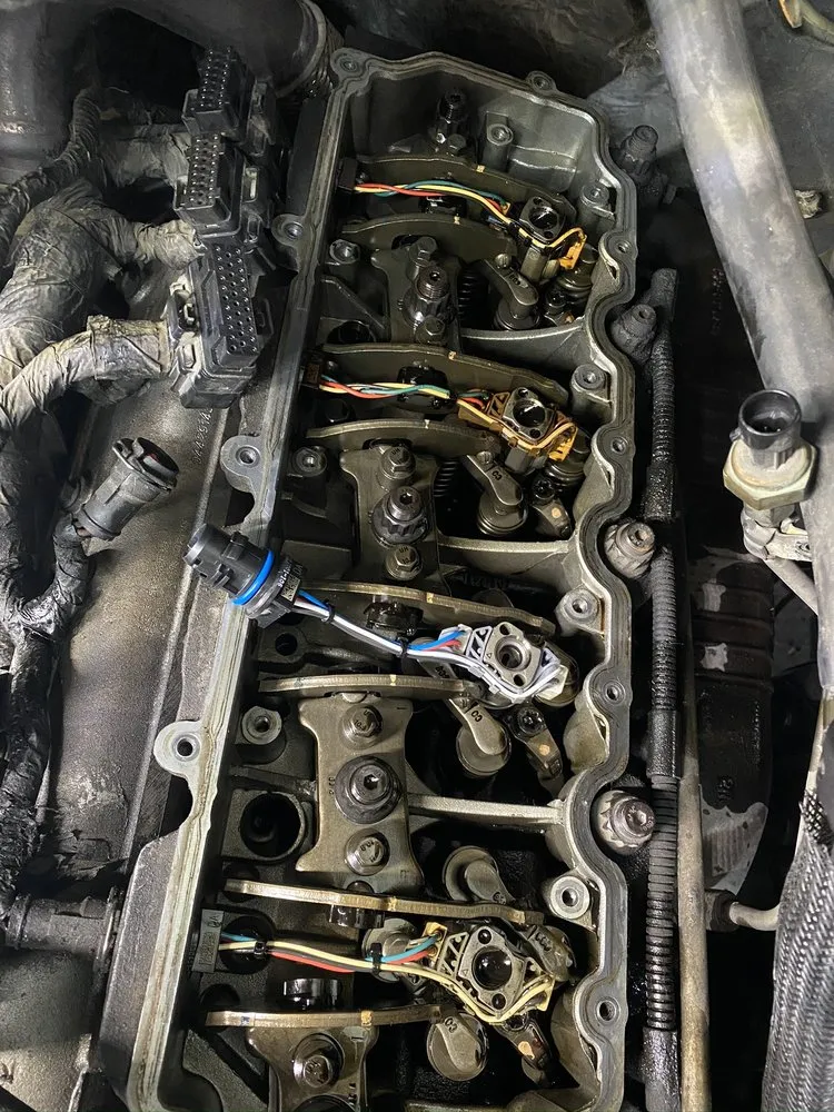 An engine with the intake removed, mid-repair