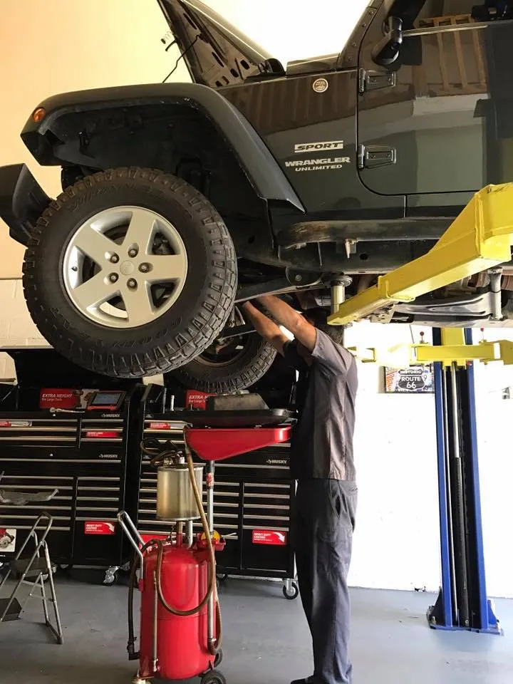 A Jeep up on the lift for undercarriage work